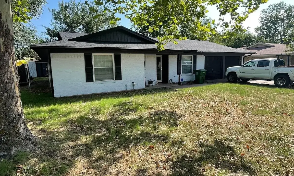 Professional roofing crew working on a residential roof in Clarkston